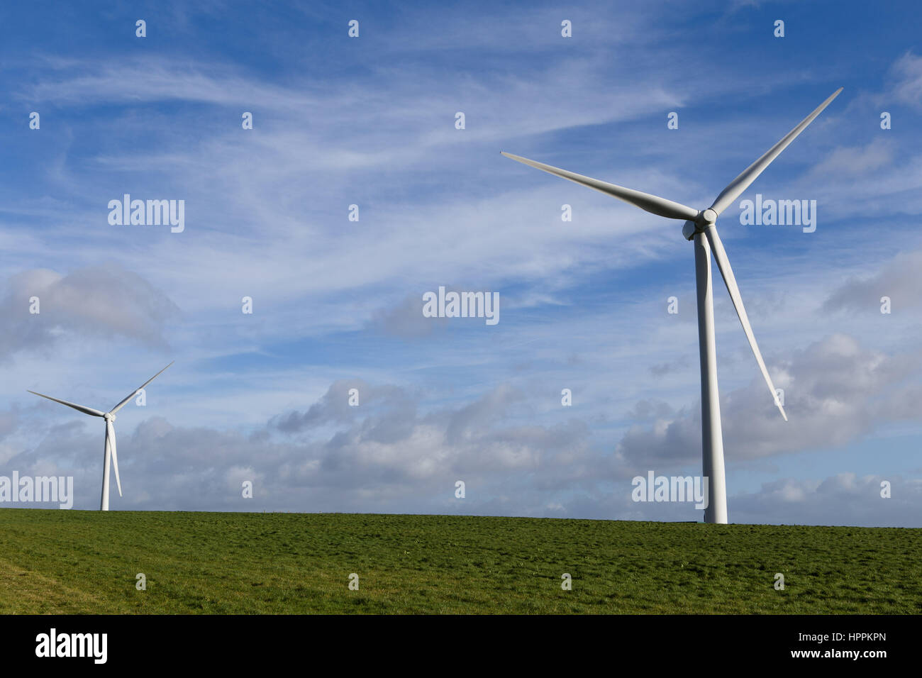 Wind turbines generate electricity on a breezy day in Devon, UK. Stock Photo