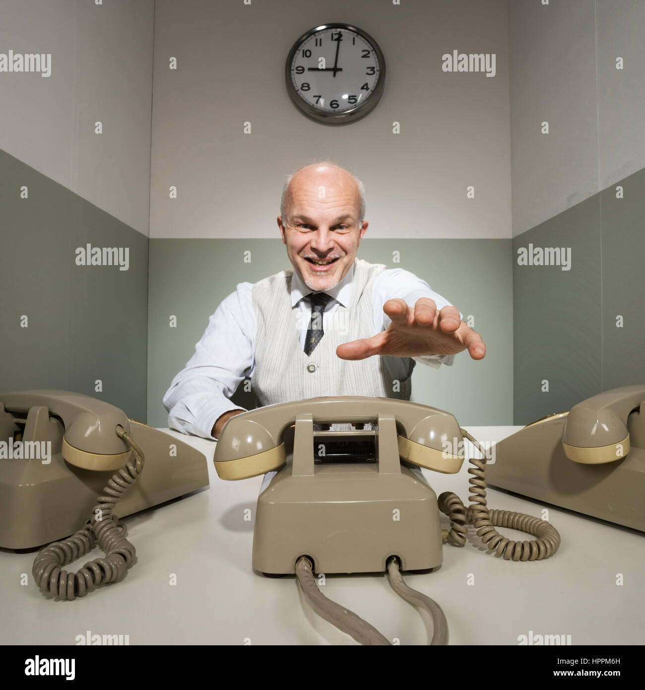 Handsome productive office worker answering calls at office Stock Photo