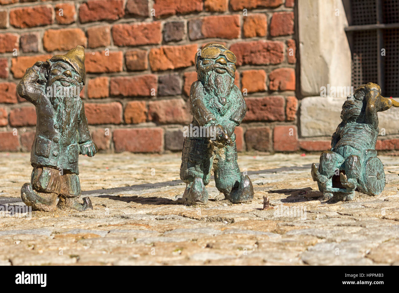 Three dwarfs symbol Wroclaw in Poland acting as the three wise monkey, deaf blind and mute Stock Photo