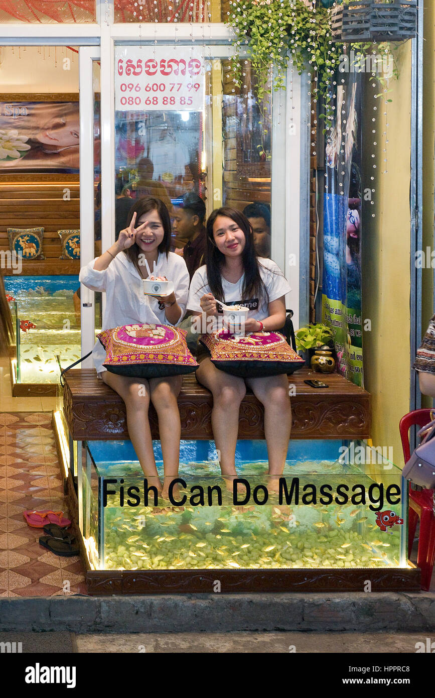 2 happy Japanese tourists in Siem Reap enjoying a fish pedicure near