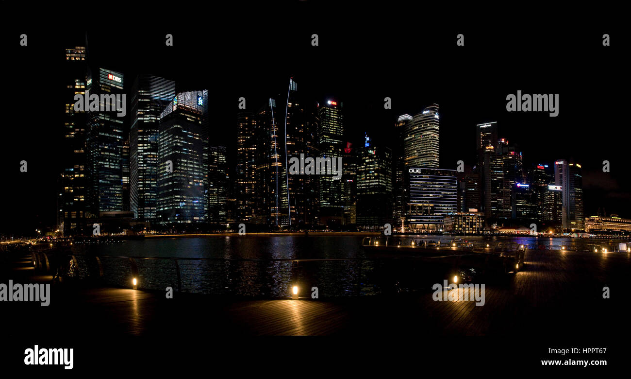 A 2 picture stitch panoramic cityscape view at night of the tower blocks and skyscrapers of the Central Business District (CBD) in Singapore. Stock Photo