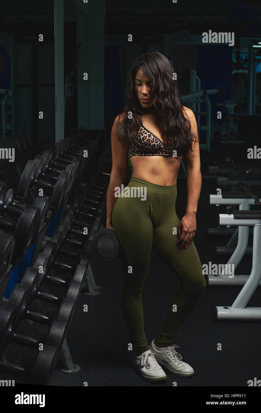 Pretty brunette in gym working hi-res stock photography and images