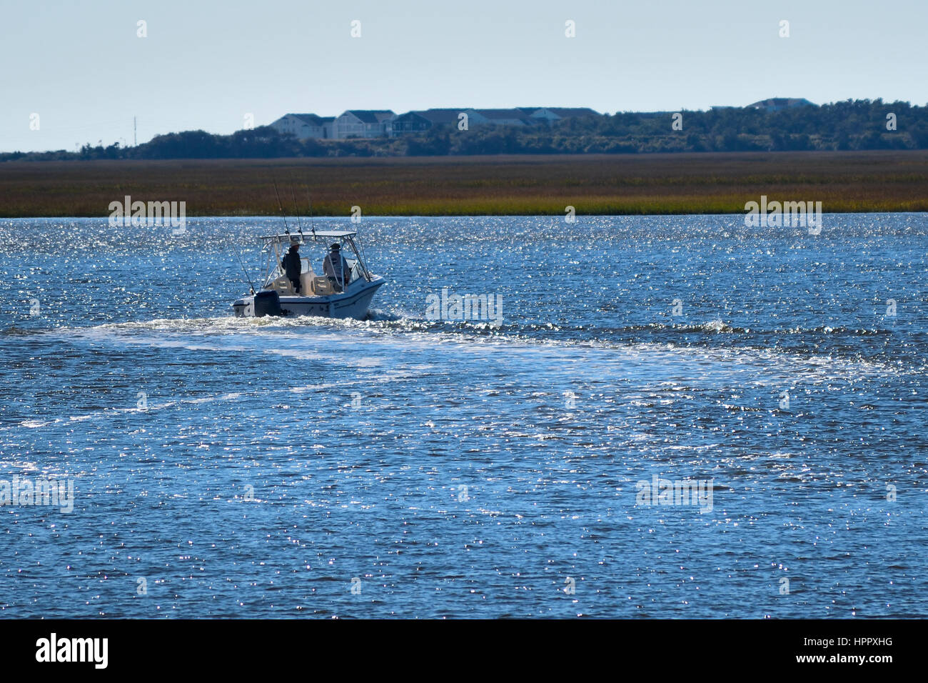 Two men looking for a good fishing spot on the Intracoastal Waterway, between Oak Island, NC and Southport, NC Stock Photo