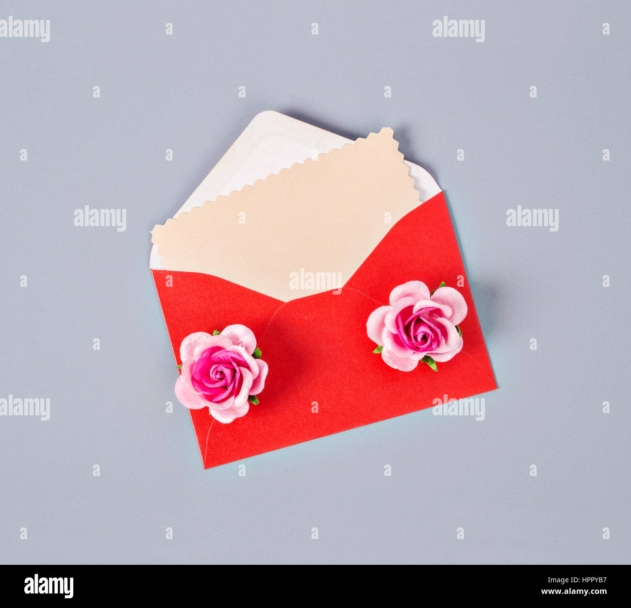 Blank pink paper card in red envelope letter with pink roses on gray ...