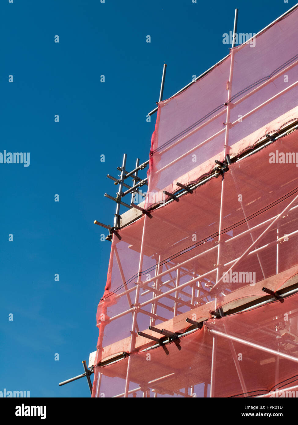 industrial scaffolding with health and safety protection mesh Stock