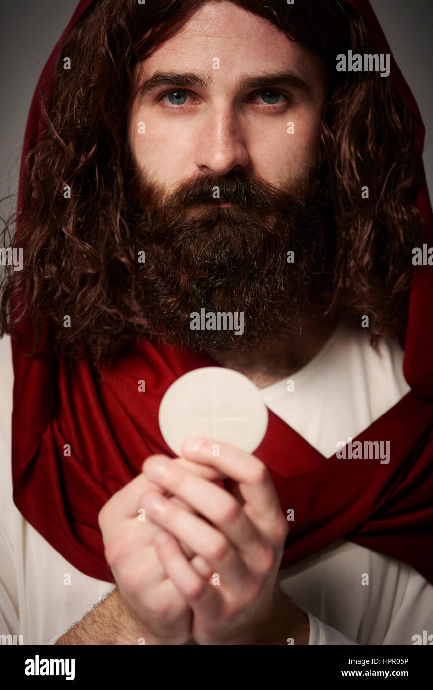 Jesus Christ holding holy Eucharist in hands Stock Photo Alamy
