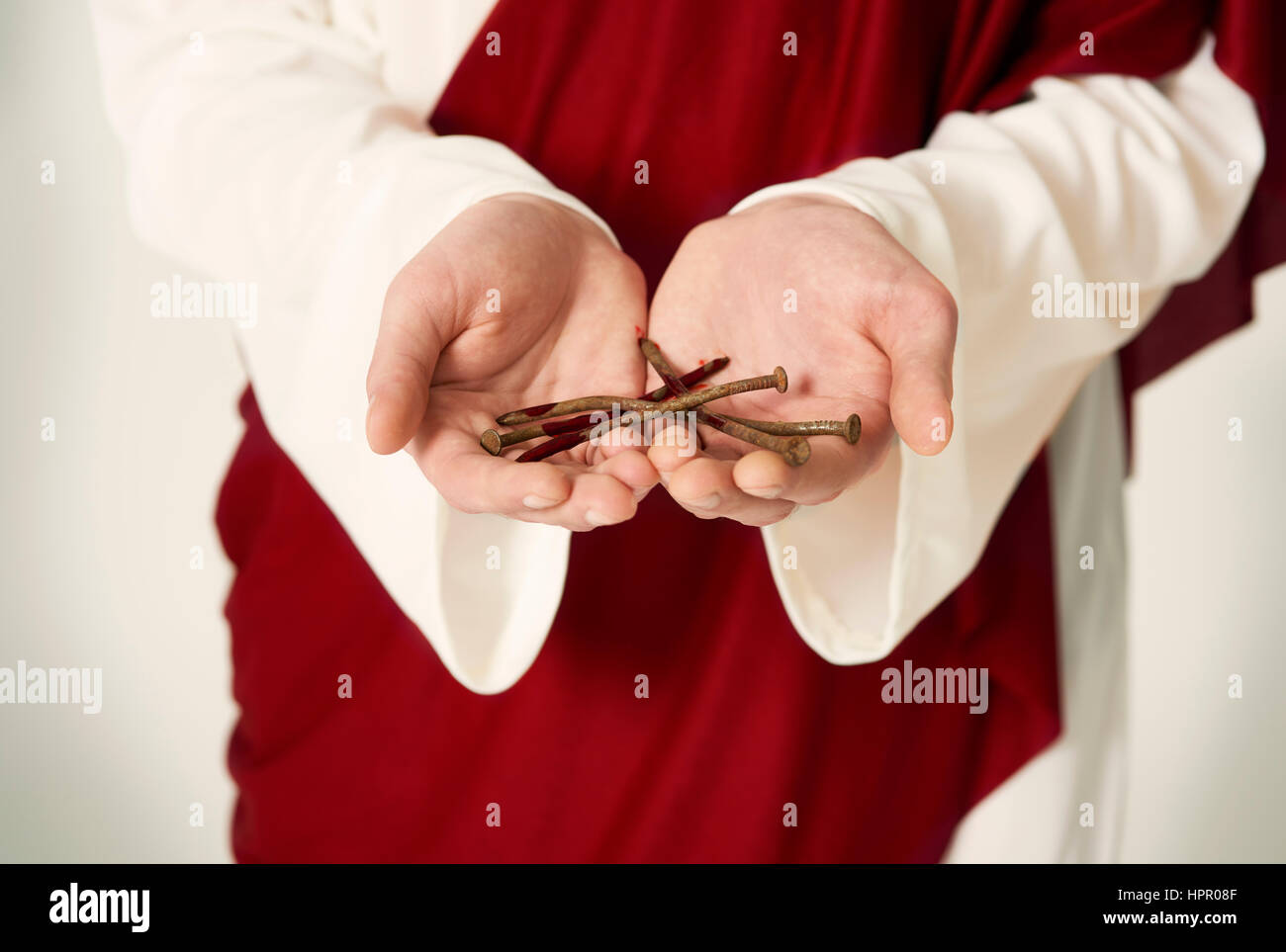 Jesus hands holding rusty nails Stock Photo