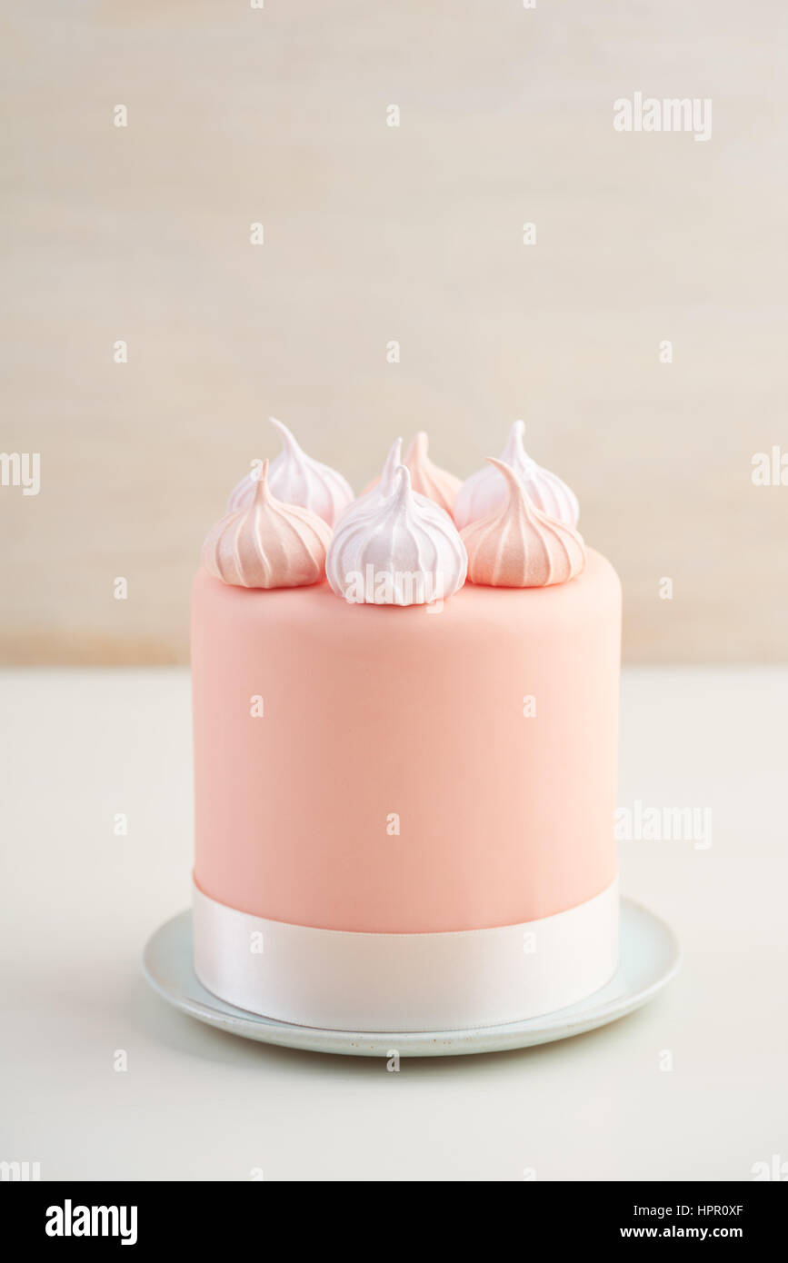 Mini fondant covered cake with meringue kisses Stock Photo Alamy