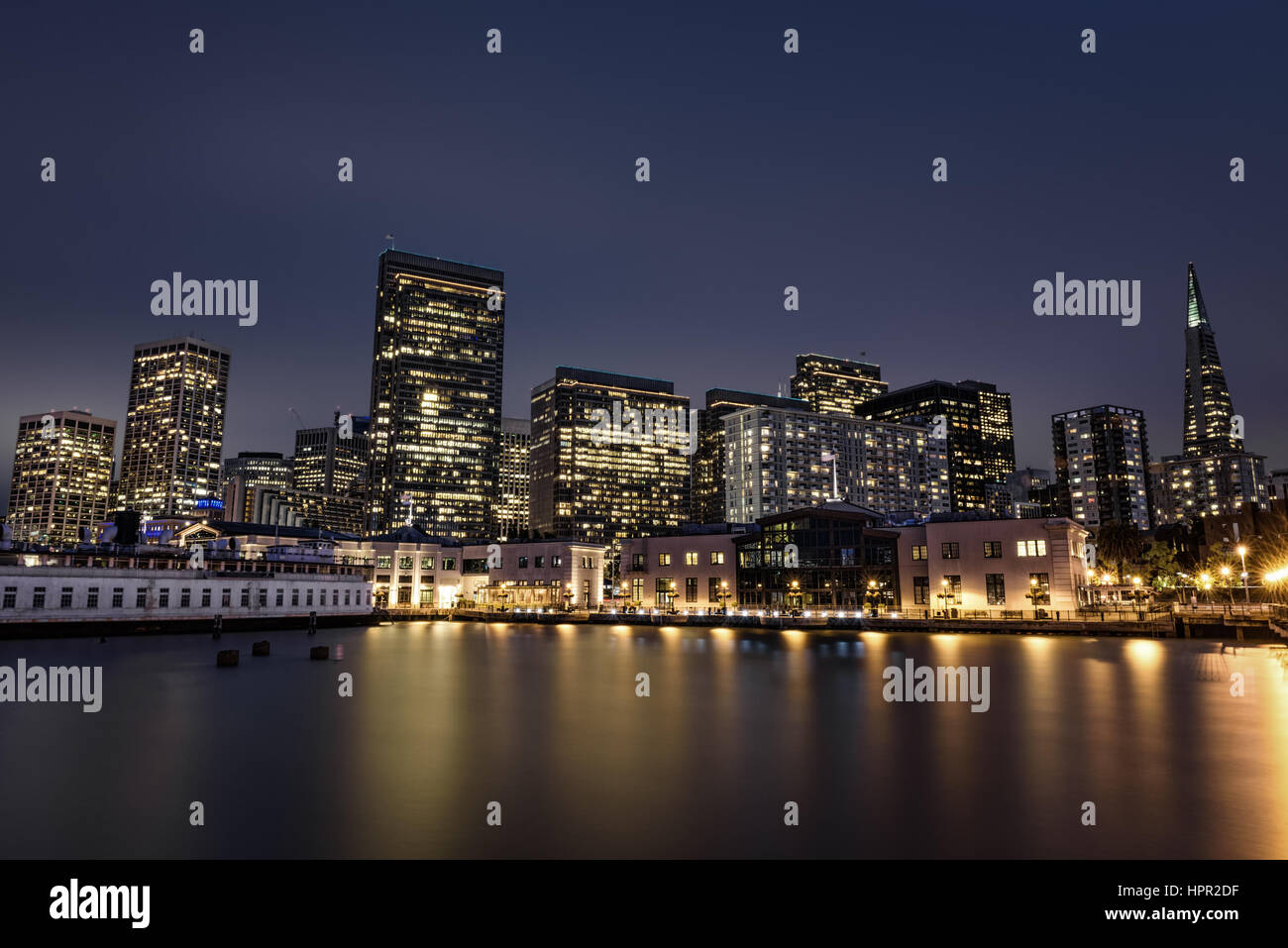 San Francisco skyline viewed from Pier 7 after sunset. Long exposure. Stock Photo