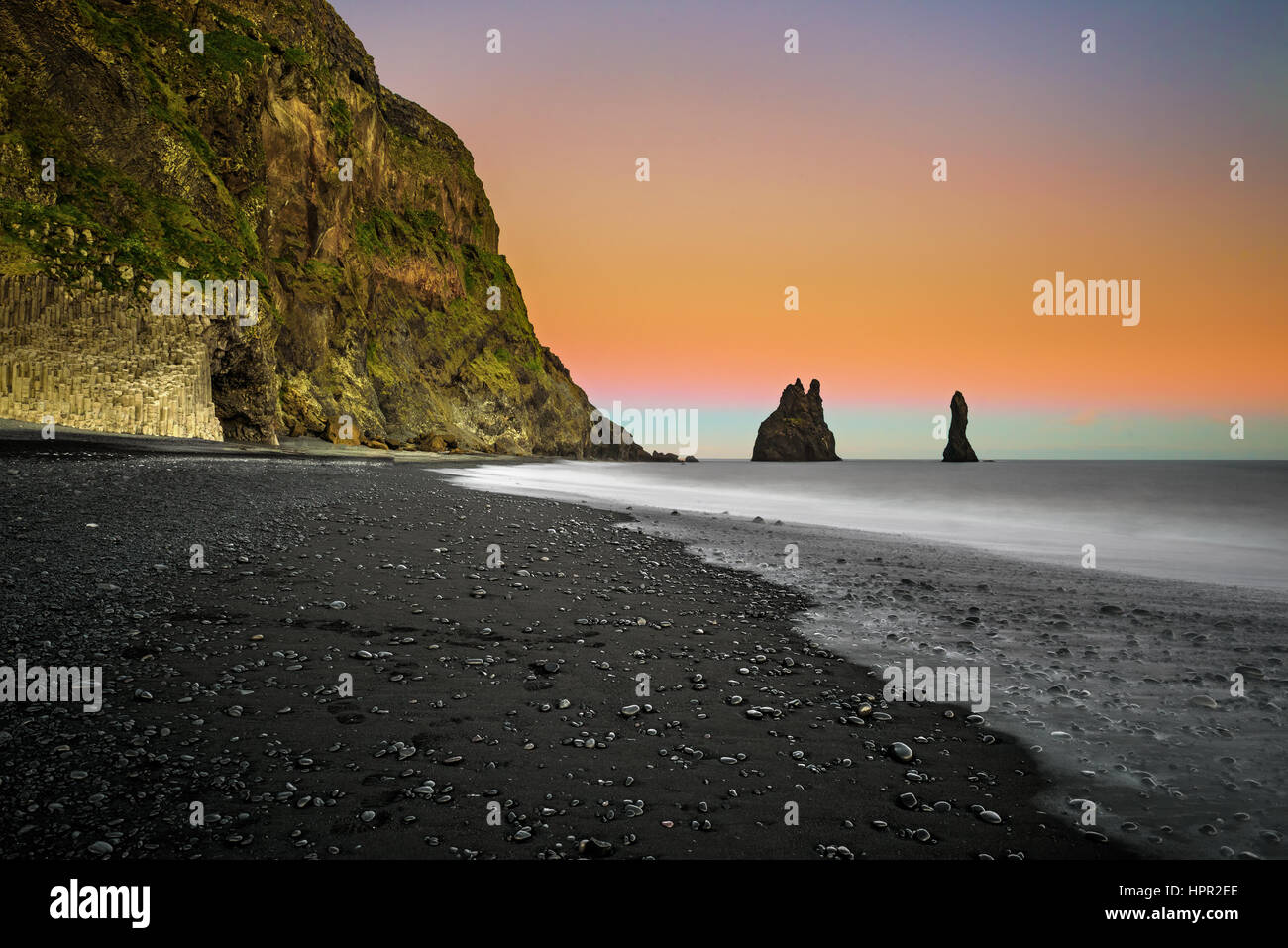 The black sand beach of Reynisfjara and the mount Reynisfjall near the village of Vik in south Iceland. Long exposure. Stock Photo