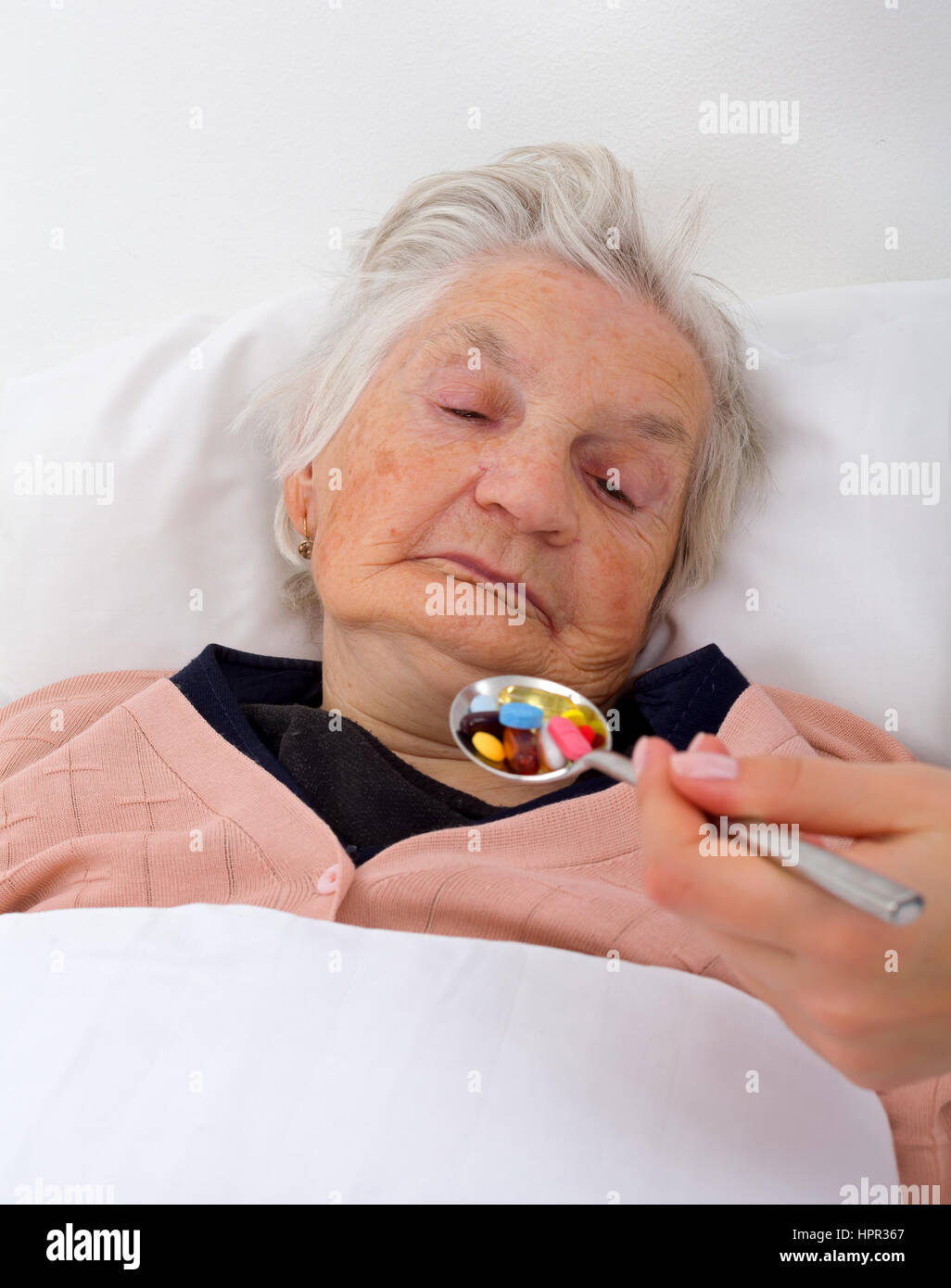 Elderly woman with her caregiver at home Stock Photo