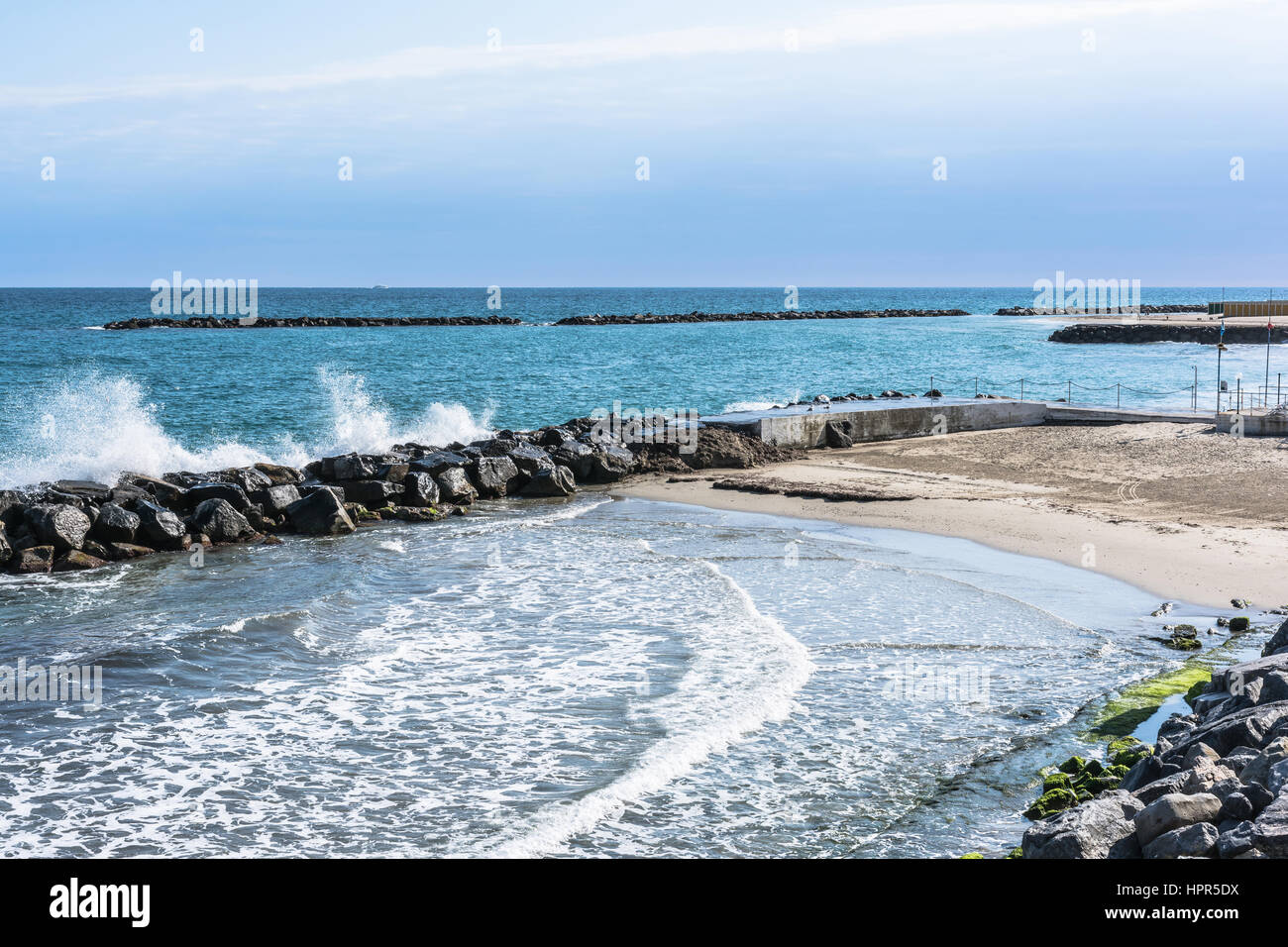 Sand beach and breakwater along the coast of Sanremo, Italy Stock Photo