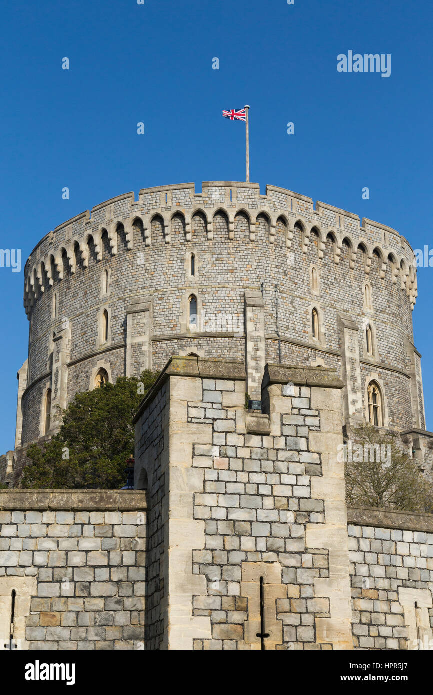 The Round Tower of Windsor Castle, & Union Flag flying which means Queen isn't there. Windsor, Berkshire. UK. Sunny day with sun and blue sky / skies. Stock Photo