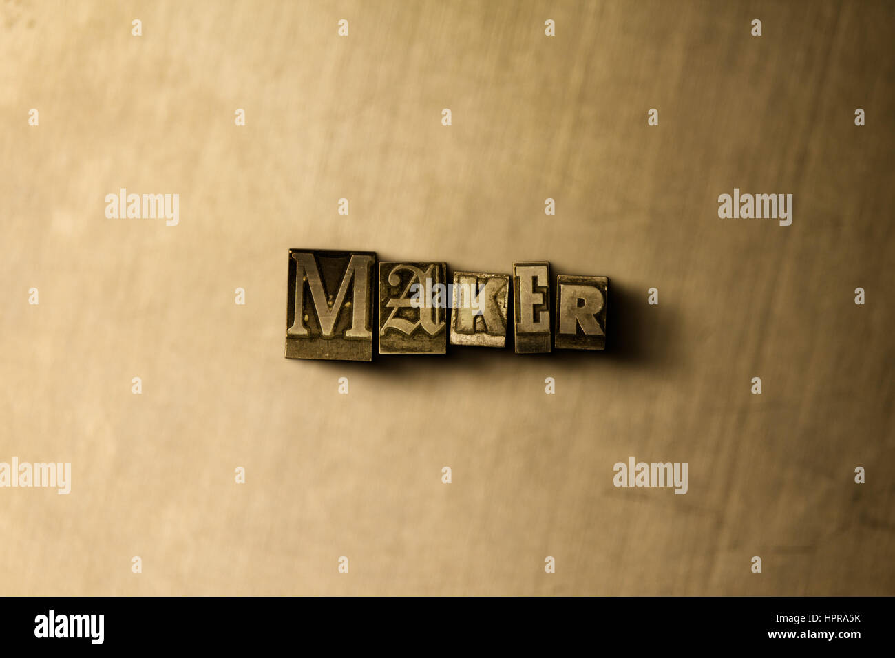 Maker Close Up Of Grungy Vintage Typeset Word On Metal Backdrop