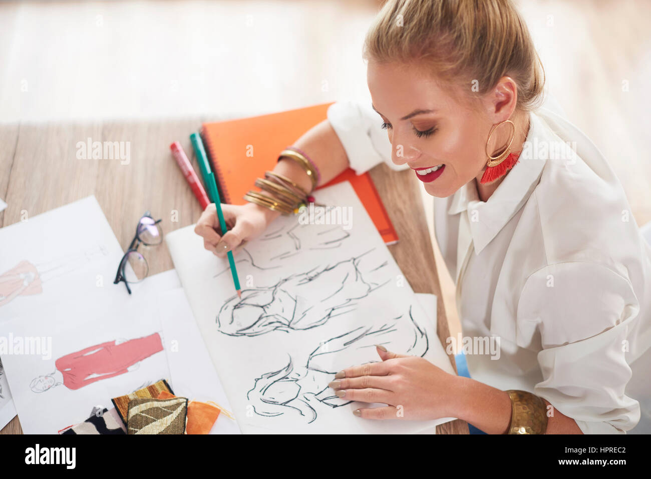 Female design professional sketching at table Stock Photo