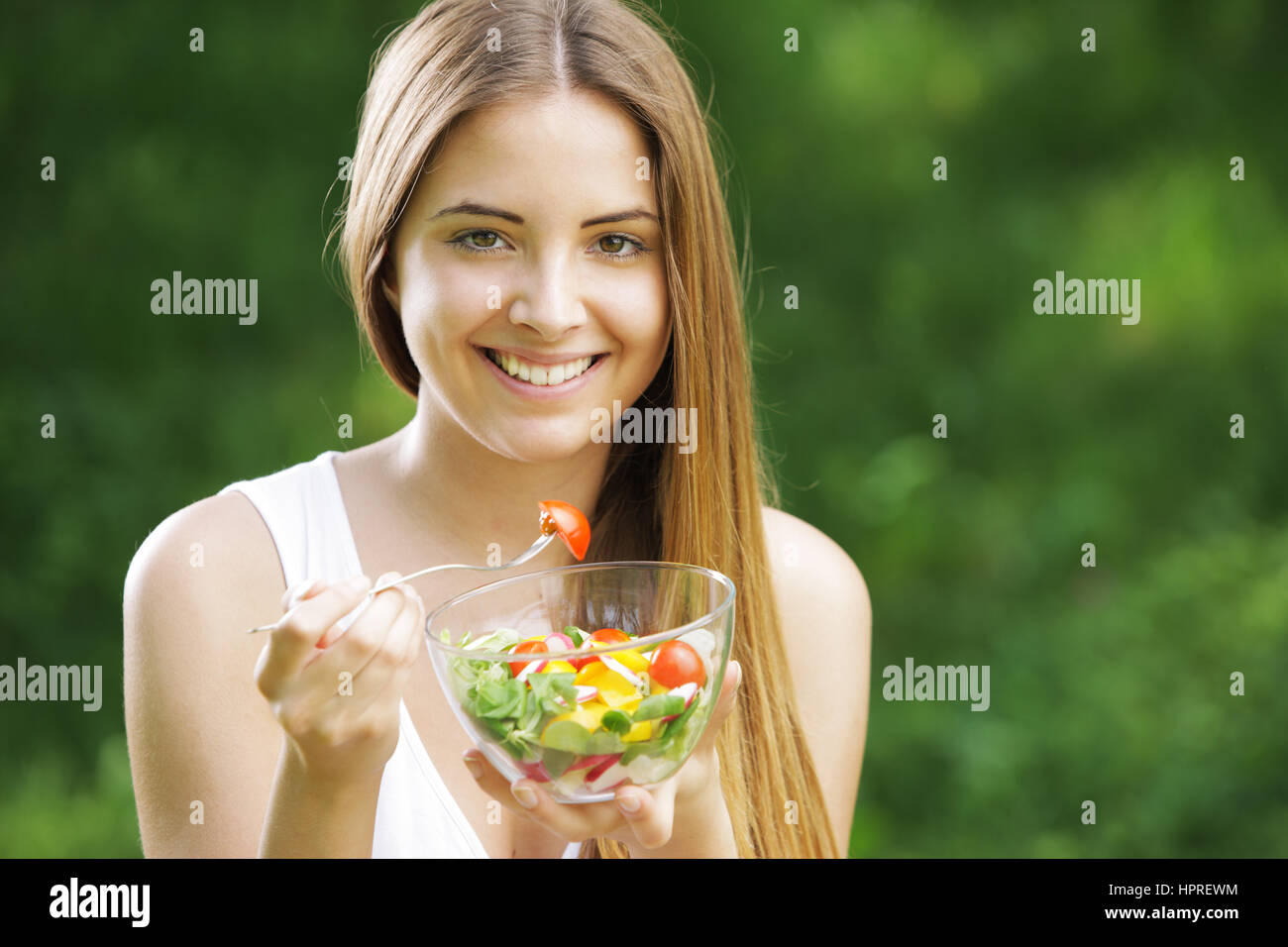 Portrait of young happy woman eating salad Stock Photo Alamy