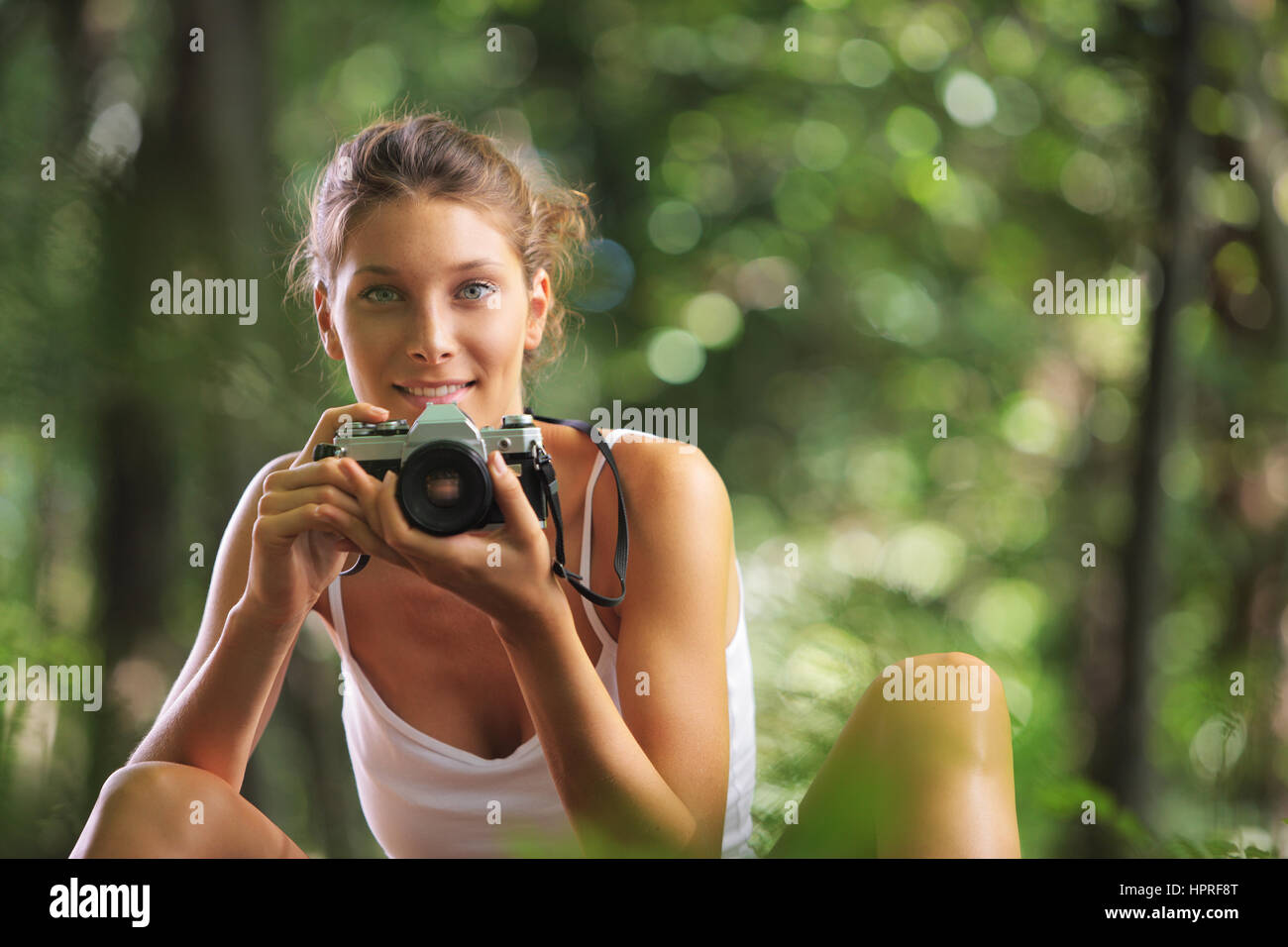Beautiful woman in the woods with vintage camera Stock Photo - Alamy