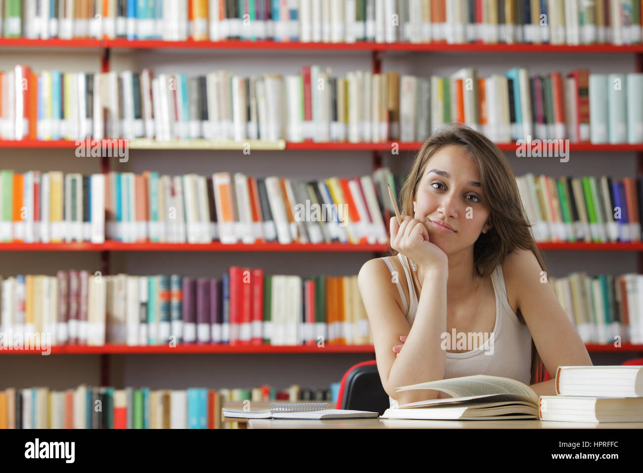 Portrait of a young student in a library Stock Photo - Alamy
