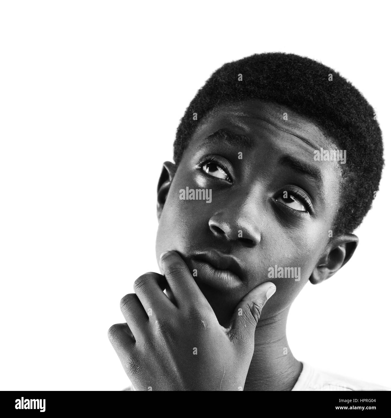 Portrait of a boy looking up at copy space, white background Stock Photo