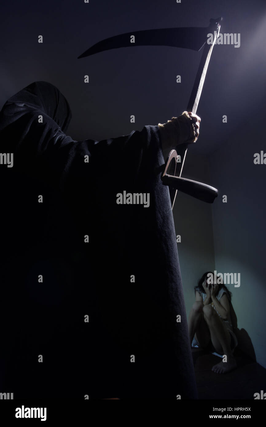 Grim reaper menace a young woman scared Stock Photo - Alamy