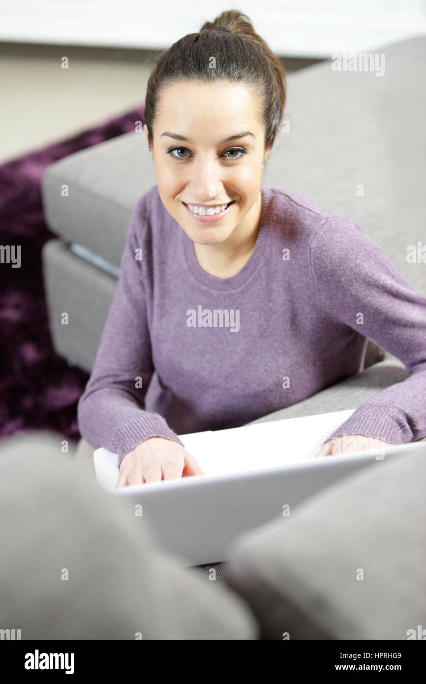 at home: young woman working on her laptop Stock Photo - Alamy