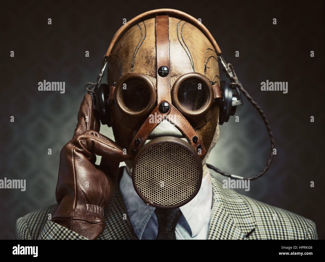 Man Wearing Vintage Gas Mask And Headphones Listening To Music