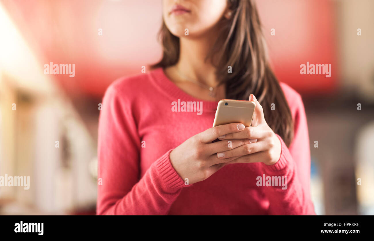 Cute young girl texting with her mobile phone Stock Photo