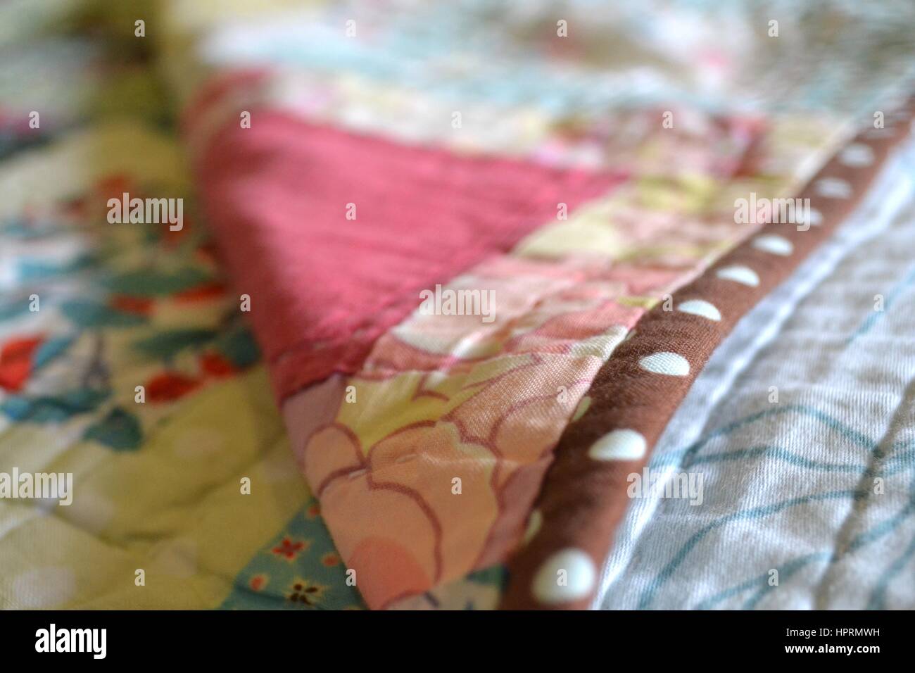 Homemade craftwork hand sewn quilt with intricate stitching Stock Photo