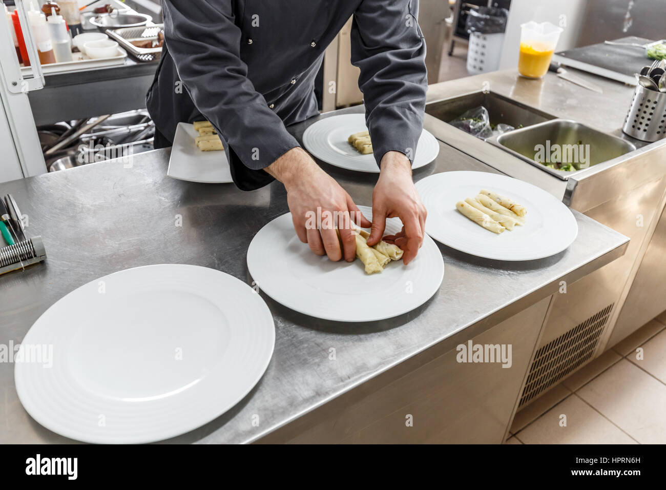 Male cooks preparing meals in restaurant kitchen Stock Photo - Alamy