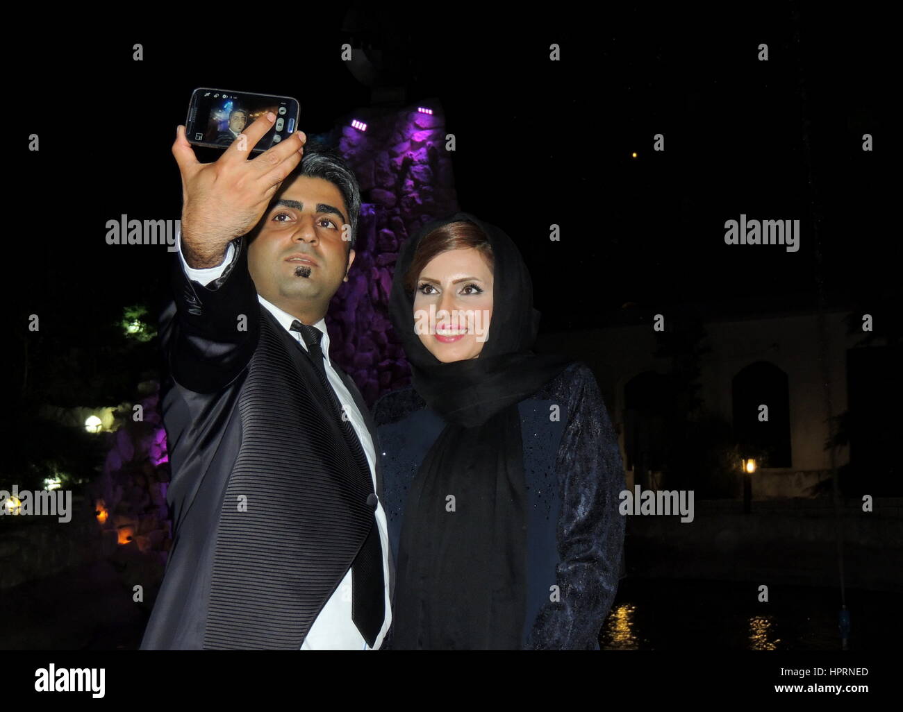 Iranian young man and woman take selfie with smartphone - Smiling people and technology Stock Photo