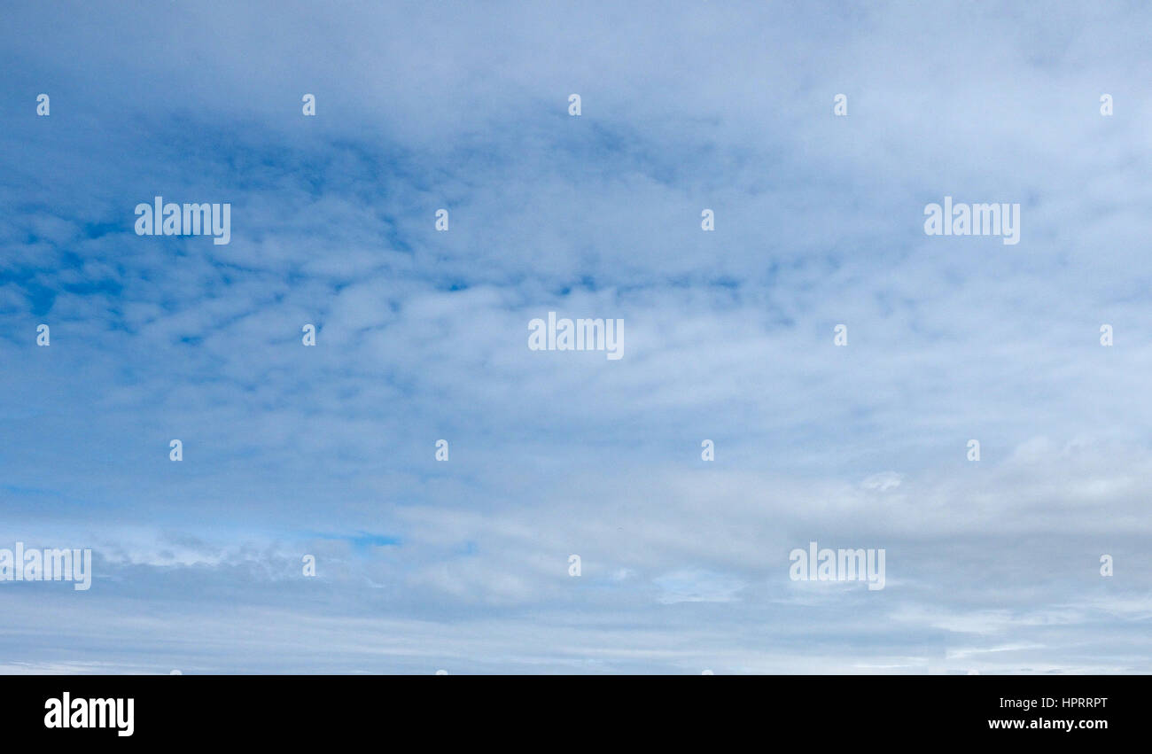 Blue sky with clouds useful as a background Stock Photo - Alamy