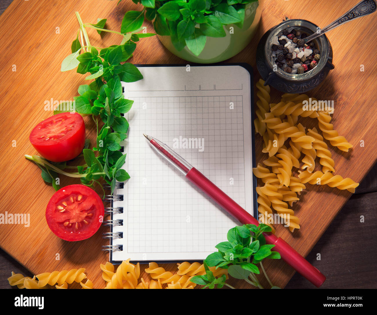 Top view of an empty recipe book surrounded of food ingredients Stock Photo