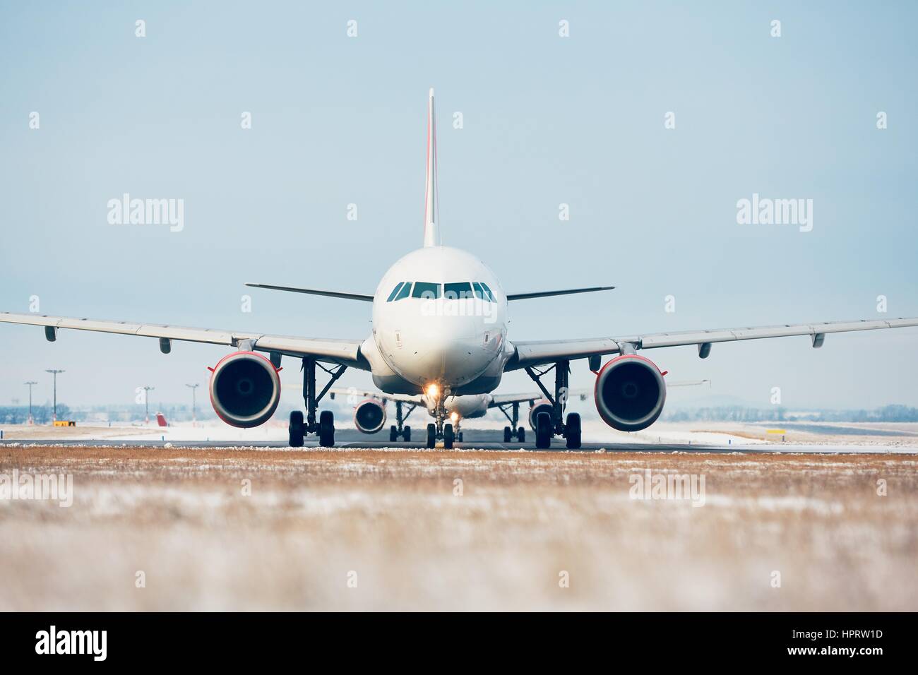 Airport in winter. Airplanes are taxiing to the runway for take off. Stock Photo