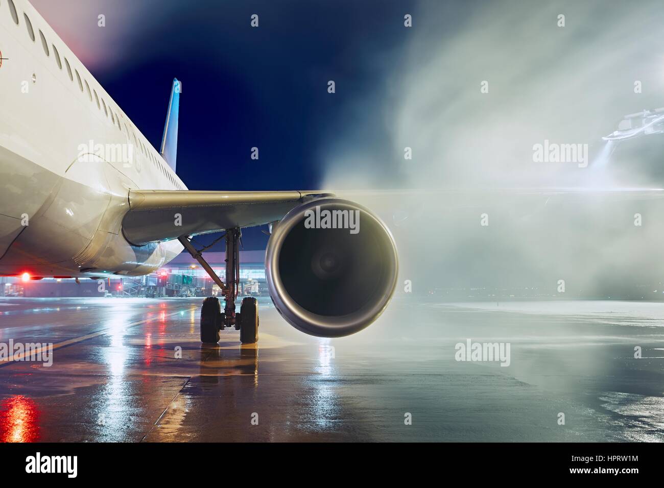 Airport in winter. Deicing of the airplane before flight. Stock Photo