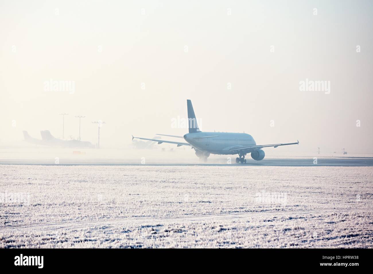 Airport in winter. Airplane is taking off in frosty day. Stock Photo