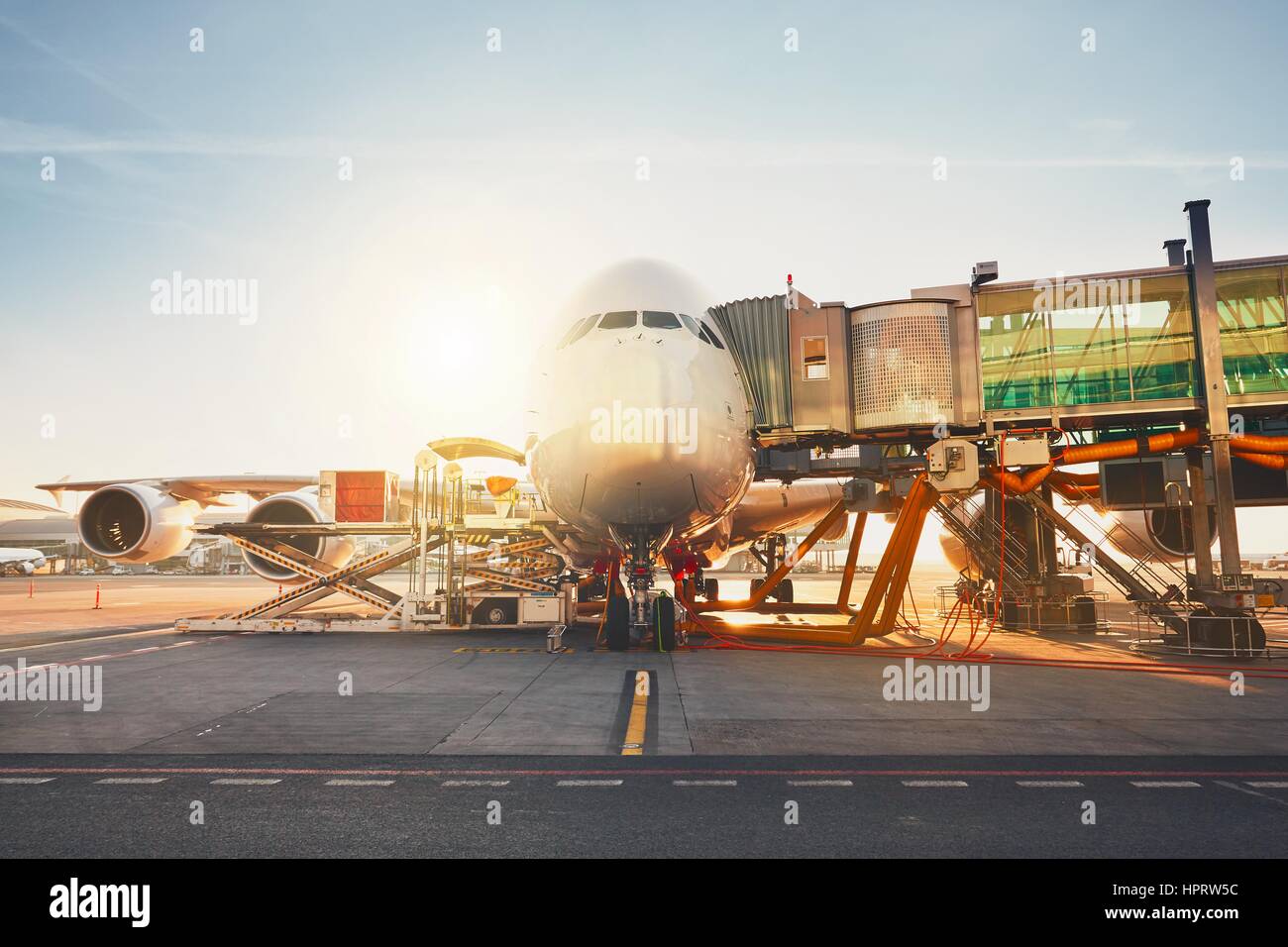 Busy airport in sunny day. Preparation of the huge airplane before flight. Stock Photo