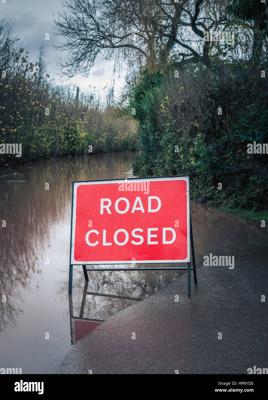 A road closed sign on a flooded country lane Stock Photo