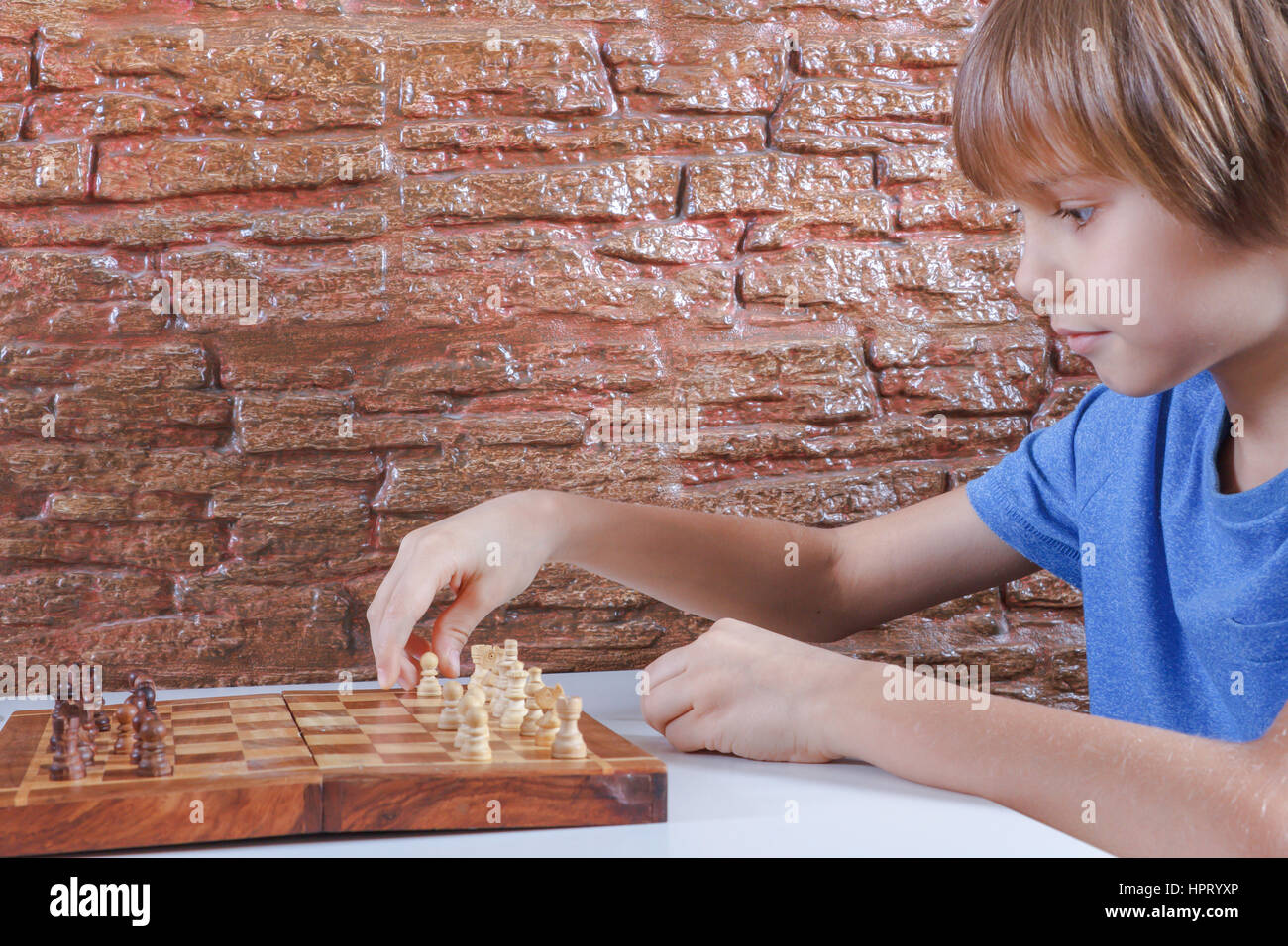 Children's Restraining Hand Thoughtfully Figure Before The Next Chess Move  Stock Photo, Picture and Royalty Free Image. Image 77247675.