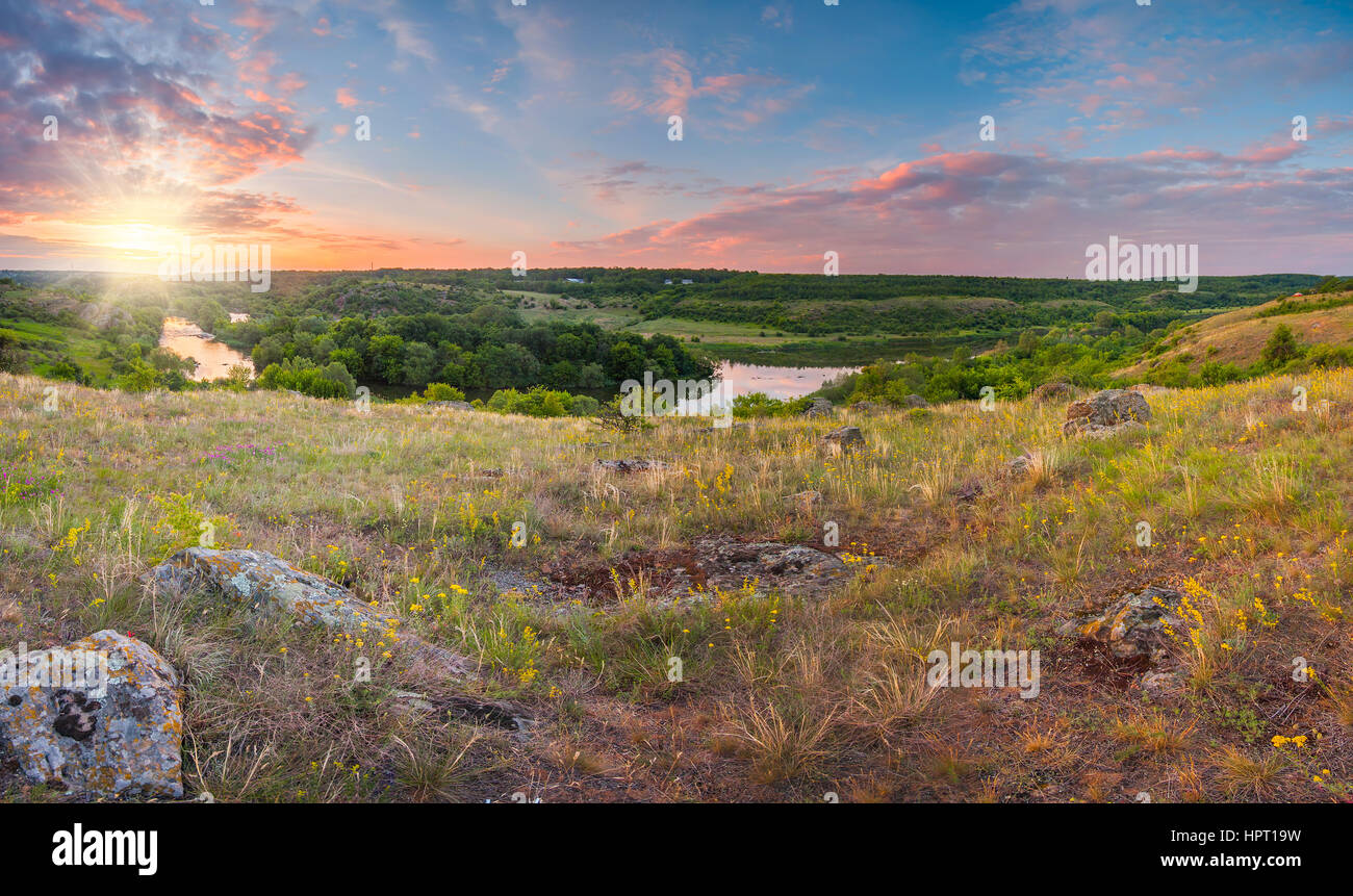 Summer sunset with blue colorful sky and green fields Stock Photo - Alamy