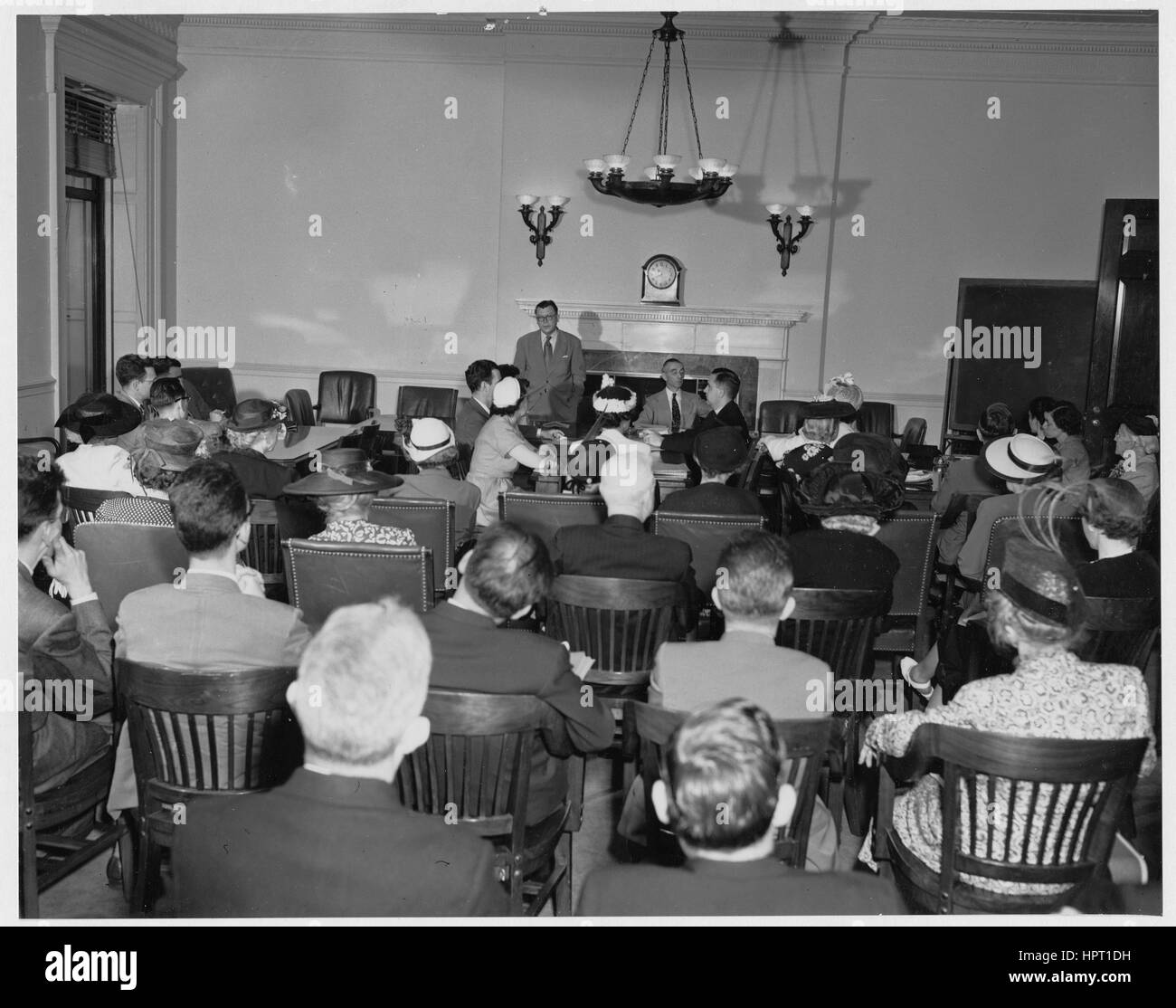 Dr. Wayne Grover, Third Archivist of the United States, stands at the front of a room addressing those participating in his classes on archives administration and genealogical research, June, 1950. Stock Photo