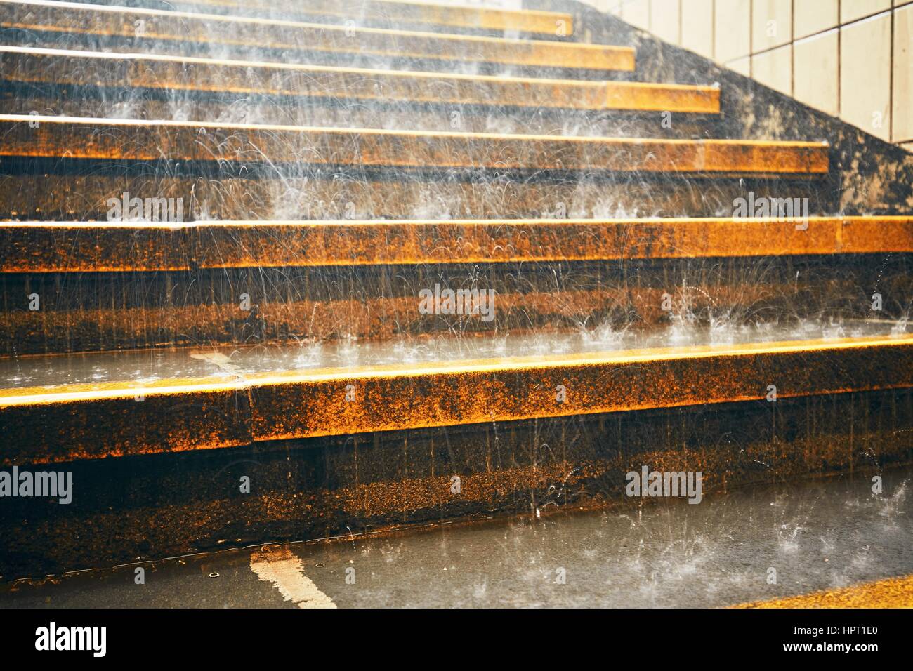 Heavy rain in the city. Rain droplets on the staircase during downpour. Stock Photo