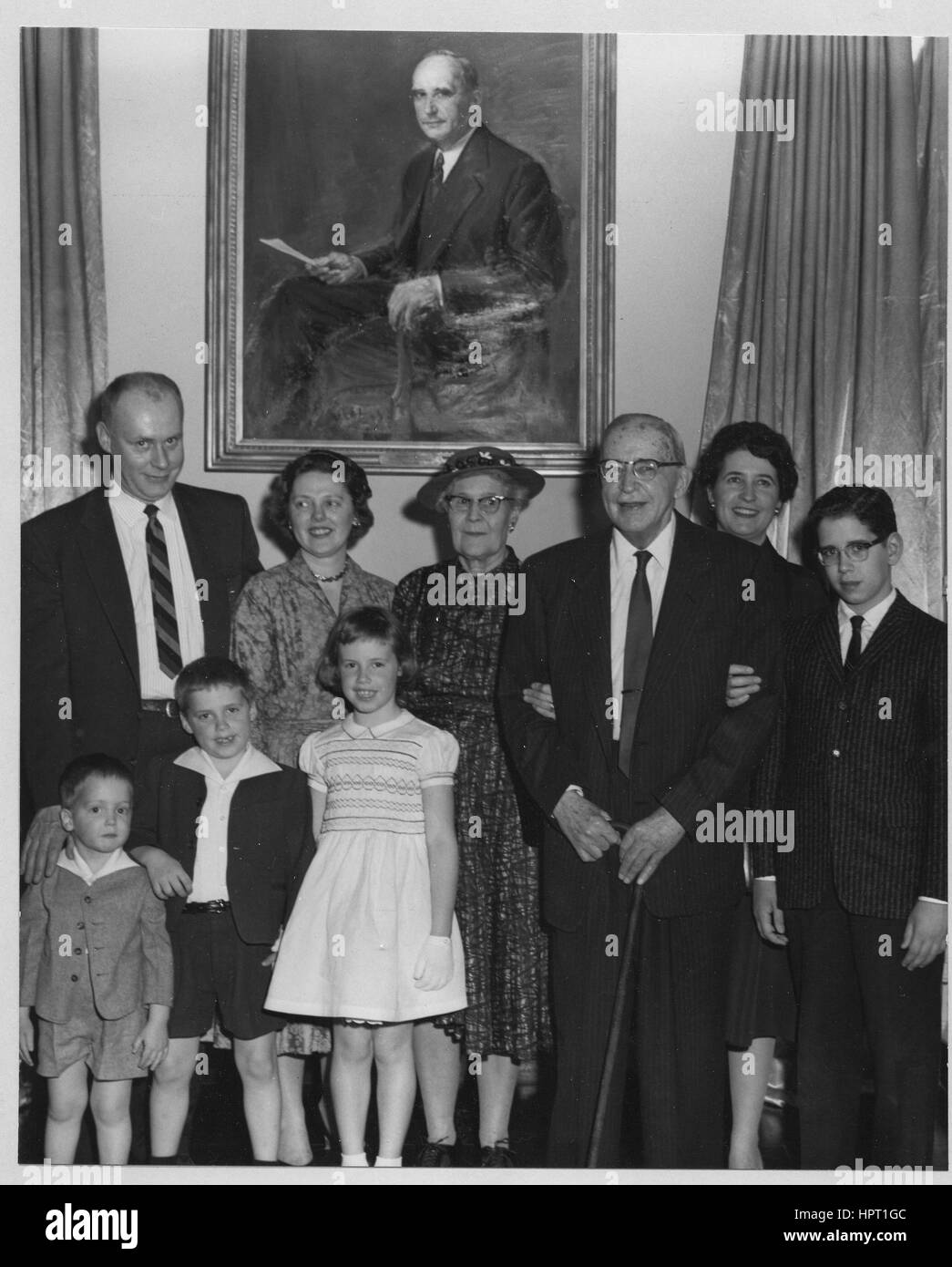 Second Archivist of the United States Dr. Solon J. Buck (third from right) and his family are gathered in front of his portrait during its unveiling ceremony, 1960. Stock Photo