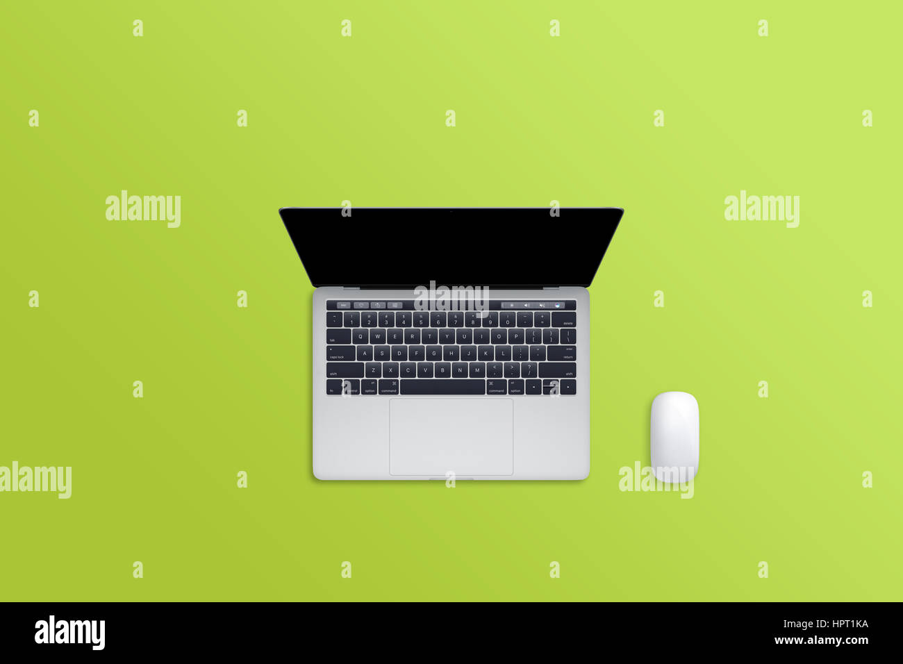 Laptop computer and mouse on green desk. Free space for text. Blank display for mockup. Stock Photo