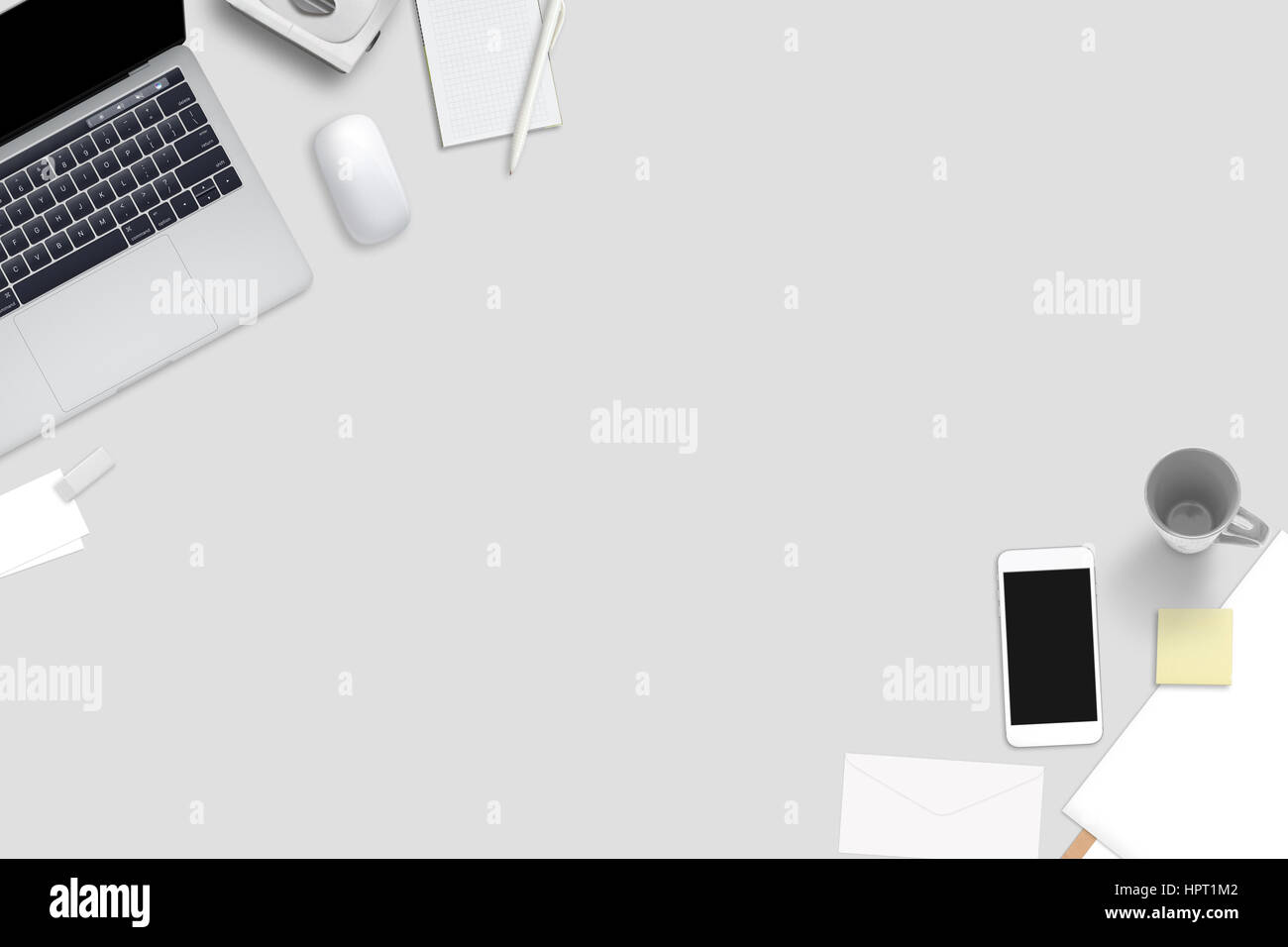 Computer, smart phone and stationery on gray desk. Top view with free space for text. Stock Photo