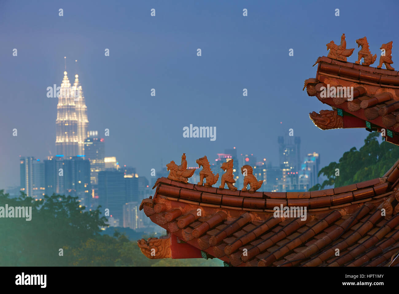 Roof of the chinese temple overlooking Petronas twin towers in Kuala Lumpur. Stock Photo