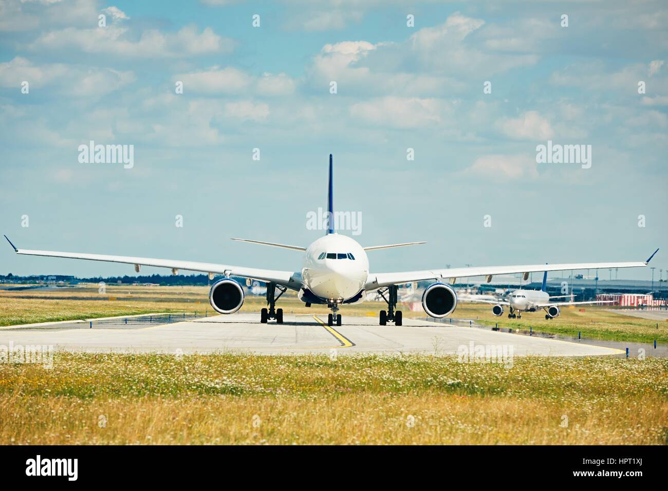 Traffic at the airport. Airplanes are taxiing to the runway for take off. Stock Photo