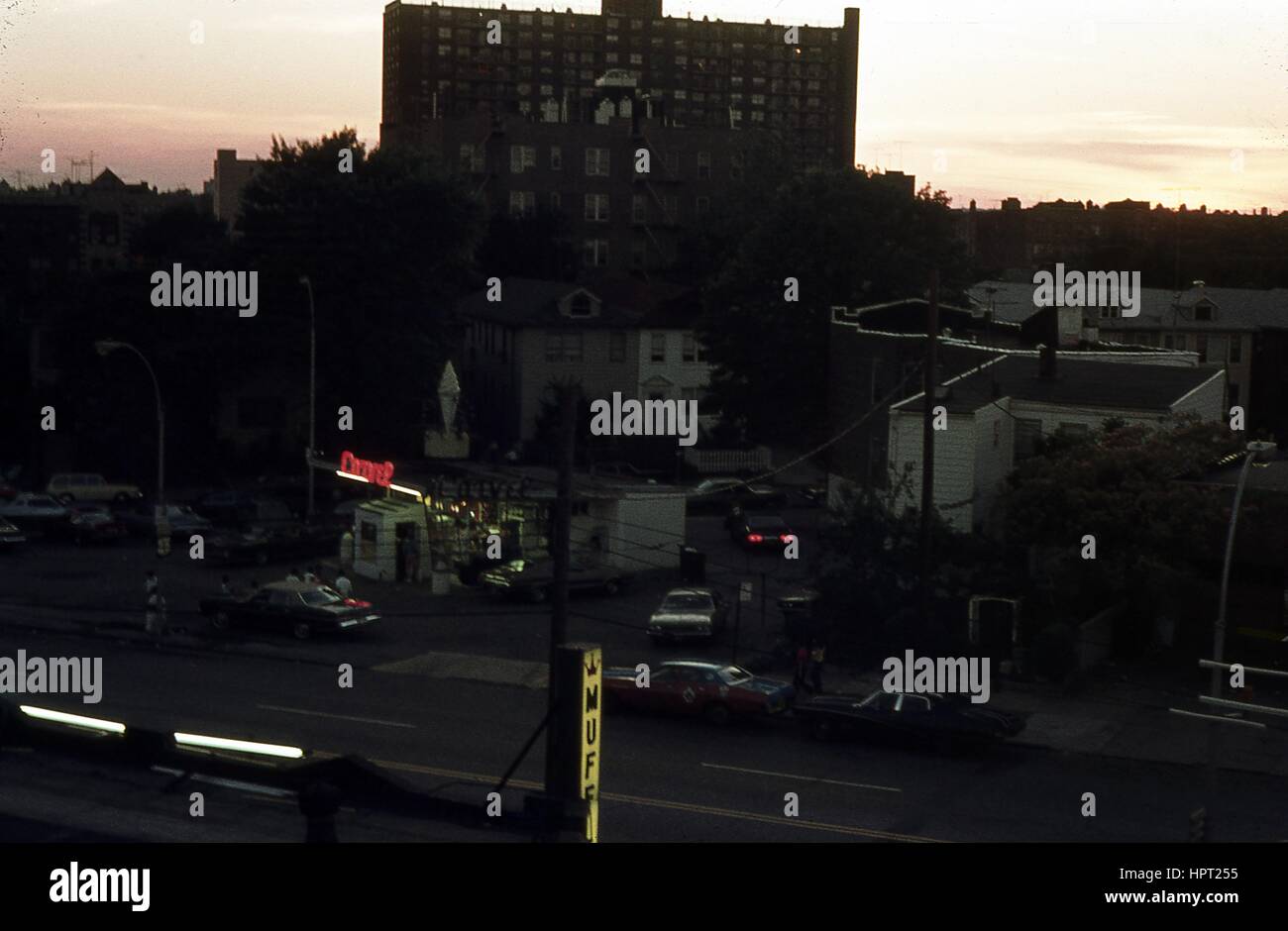 At dusk, neon signs illuminate a Carvel ice cream parlor outside a