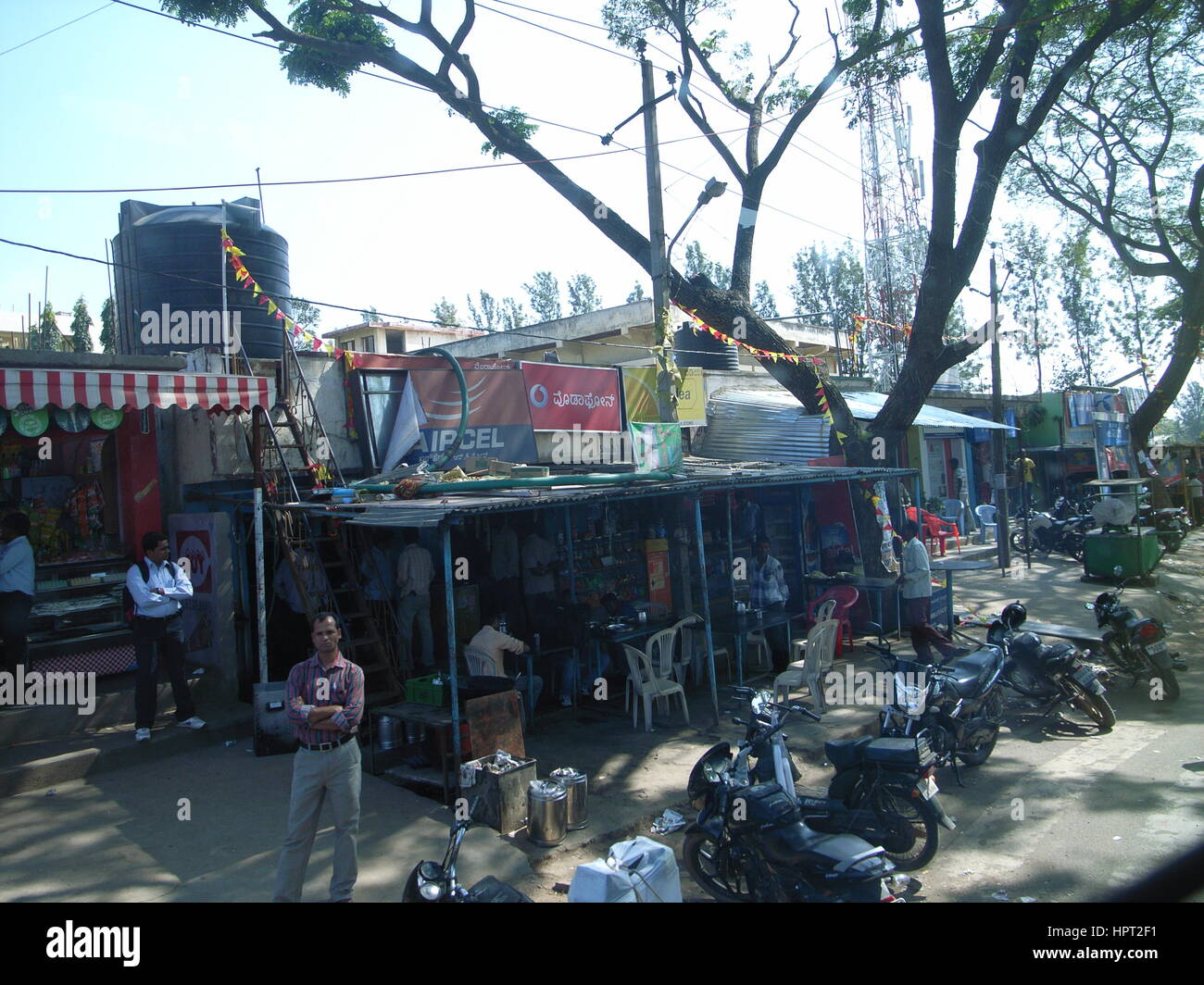 Street shops in Bangalore India, taken from bus Stock Photo