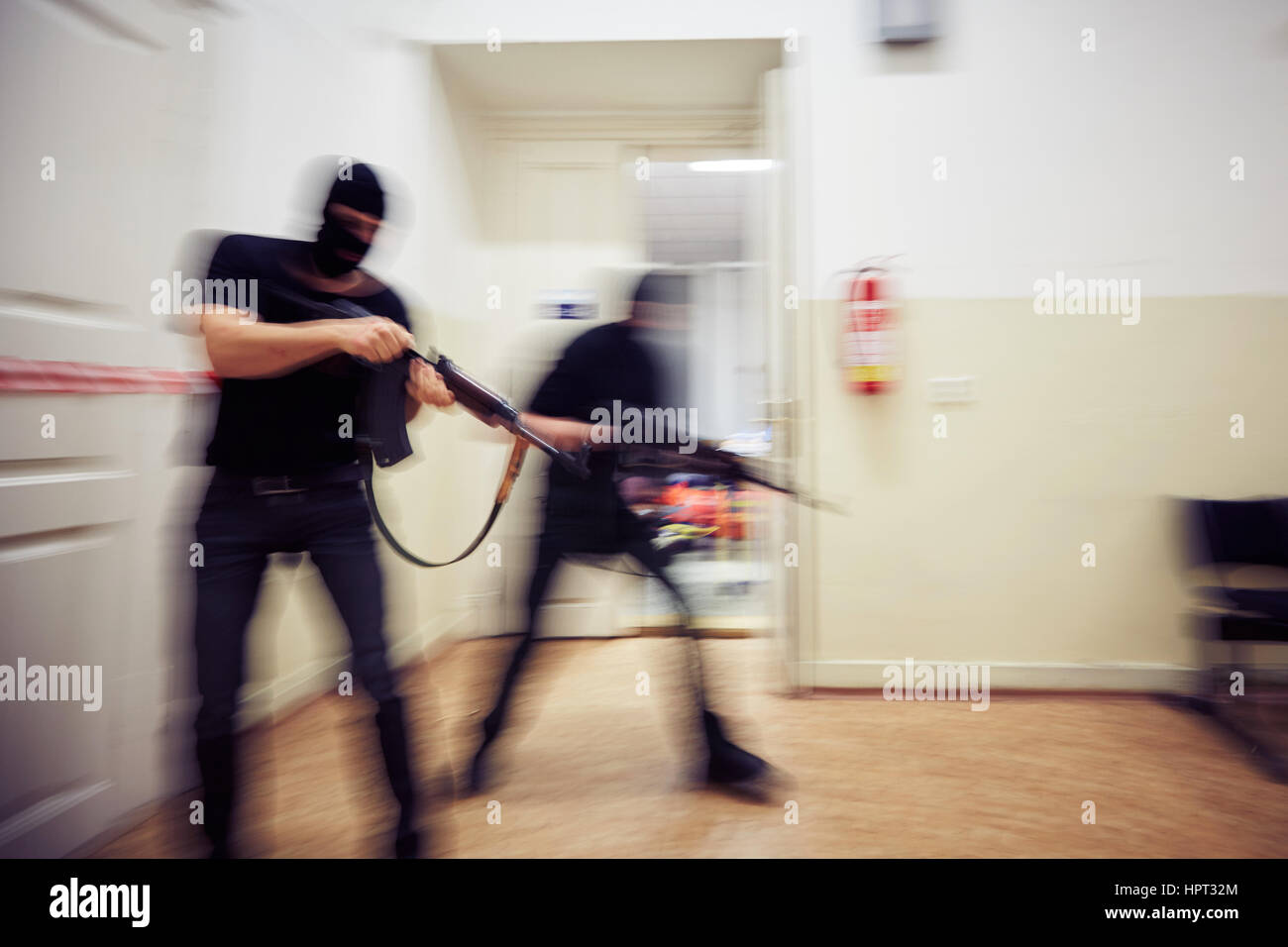 Two terrorists with rifles in the building - defocused Stock Photo