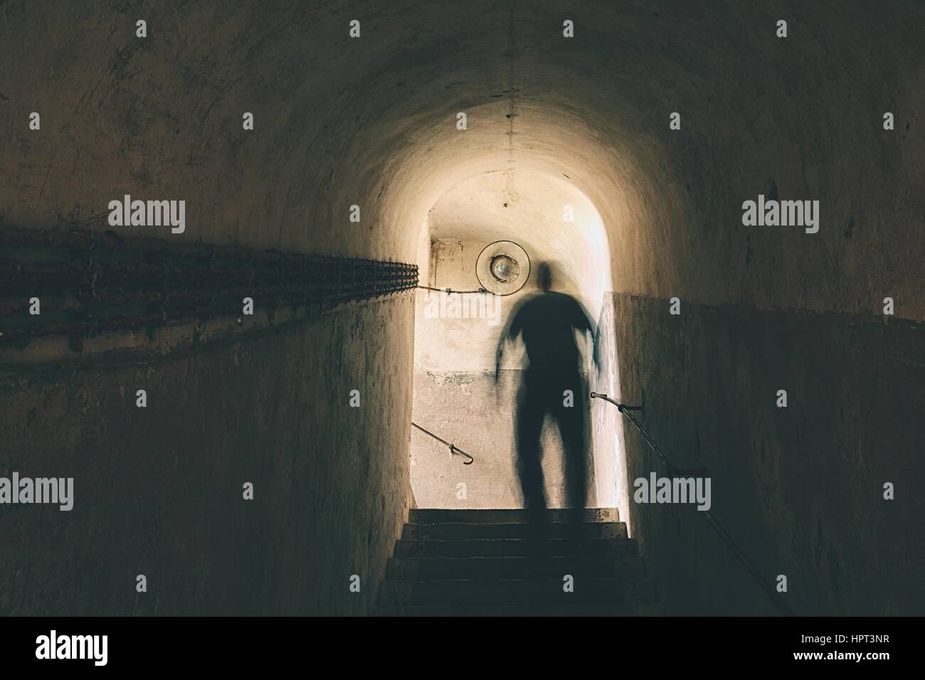 Man is walking through dark underground Stock Photo